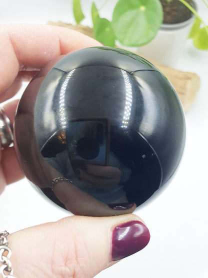 Obsidian Sphere with flashes of colour