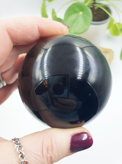 Obsidian Sphere with flashes of colour