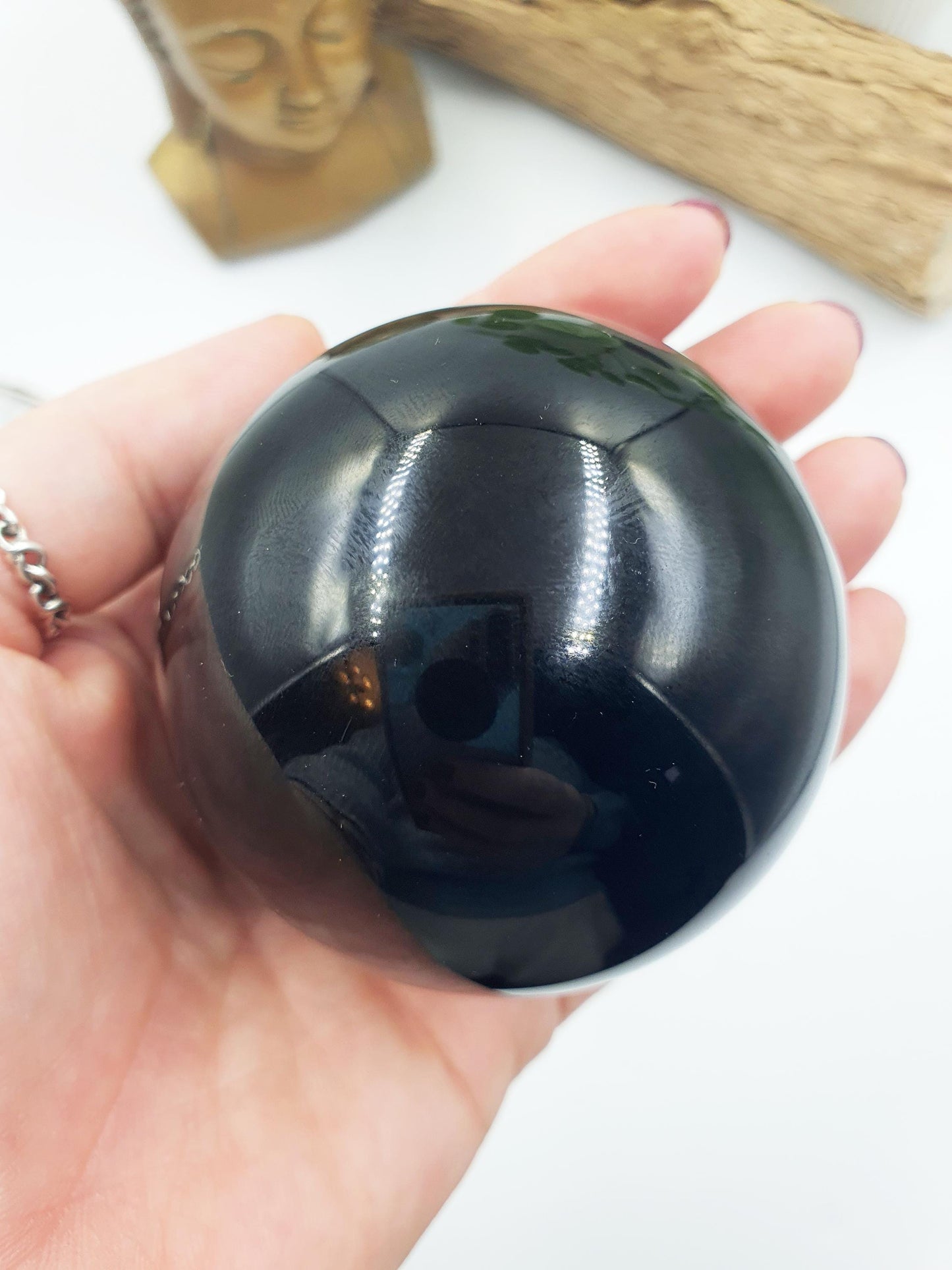 Obsidian Sphere with flashes of colour